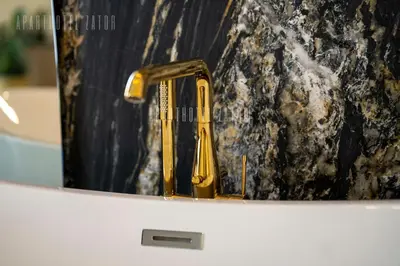 a gold faucet sitting on top of a sink at Aparthotel ZATOR Glam 52 jacuzzi in Zator