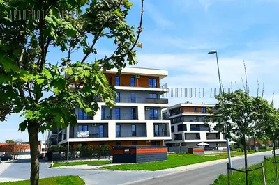 a large building on the side of a street at Aparthotel ZATOR Glam 52 jacuzzi in Zator