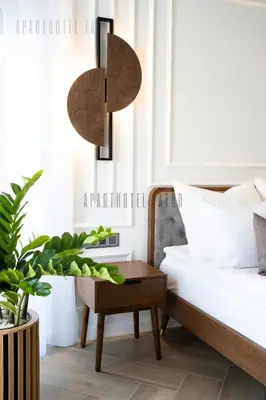 a bedroom with a bed and a table and a plant at Aparthotel ZATOR Retro 66 jacuzzi in Zator