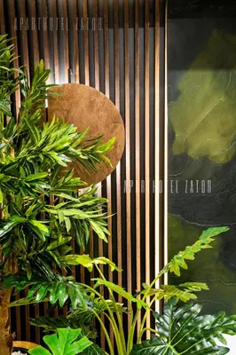 a wooden fence with some plants in front of it at Aparthotel ZATOR Retro 66 jacuzzi in Zator
