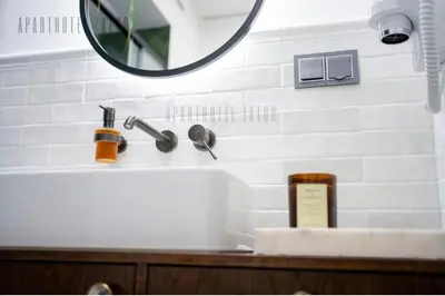 a bathroom with a sink and a mirror at Aparthotel ZATOR Retro 66 jacuzzi in Zator