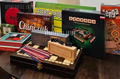 a table with a toy train and boxes of books at Aparthotel ZATOR Retro 66 jacuzzi in Zator