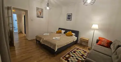 a bedroom with a bed and a couch at Apartamenty Nikodem in Old Town - Krakow center in Kraków