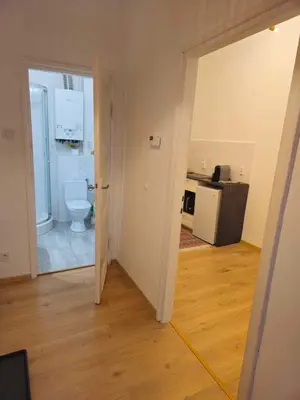 an empty room with a toilet and a kitchen at Apartamenty Nikodem in Old Town - Krakow center in Kraków