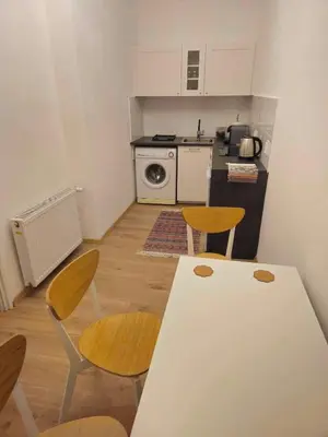 a kitchen with a table and chairs in a room at Apartamenty Nikodem in Old Town - Krakow center in Kraków