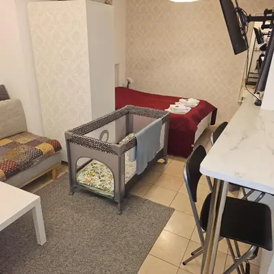 a baby crib in a room with a table at Apartamenty Nikodem in Old Town - Krakow center in Kraków