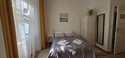 a bedroom with a bed with two towels on it at Apartamenty Nikodem in Old Town - Krakow center in Kraków