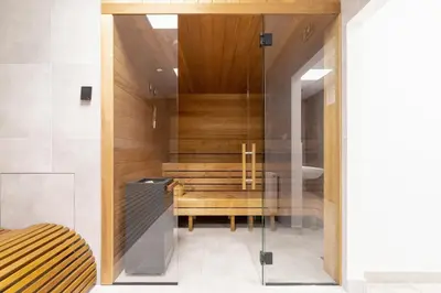 a bathroom with a wooden bench in a room at Cozy Studio Apartments Sauna & AC Kraków by Noclegi Renters in Kraków