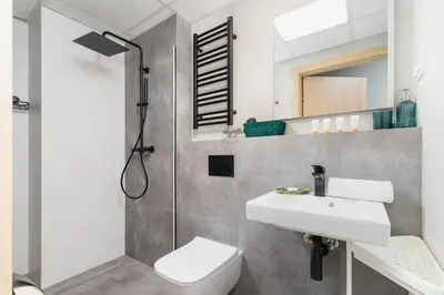 a bathroom with a sink and a toilet and a shower at Cozy Studio Apartments Sauna & AC Kraków by Noclegi Renters in Kraków