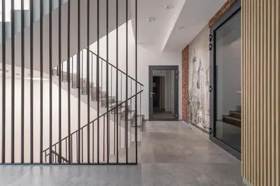 a hallway with a staircase in a building at Cozy Studio Apartments Sauna & AC Kraków by Noclegi Renters in Kraków