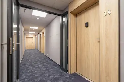a corridor of a hallway with wooden walls and a corridorngthngthngthngthngth at Cozy Studio Apartments Sauna & AC Kraków by Noclegi Renters in Kraków