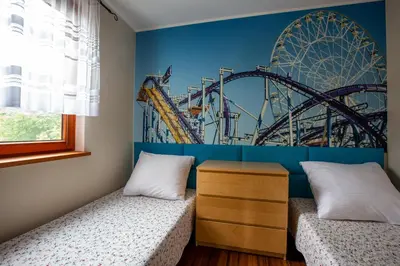 two beds in a room with a roller coaster at Dom z Widokiem Mucharz 405 in Mucharz