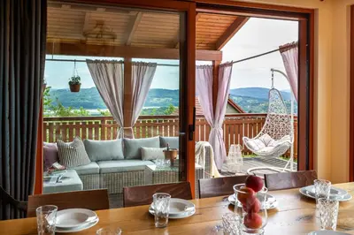 a dining room with a view of a living room at Dom z Widokiem Mucharz 405 in Mucharz