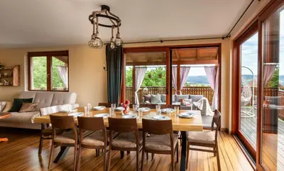 a dining room with a table and chairs at Dom z Widokiem Mucharz 405 in Mucharz