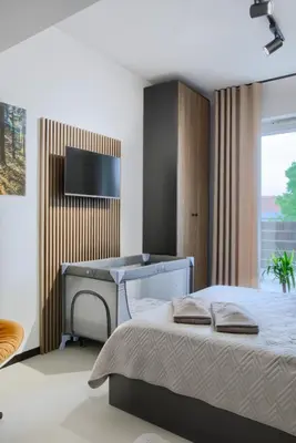 a bedroom with a bed and a desk at Premium Apartment Eleven in Zator