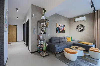 a living room with a blue couch and a table at Premium Apartment Eleven in Zator