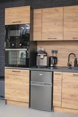 a kitchen with wooden cabinets and a stove at Premium Apartment Eleven in Zator