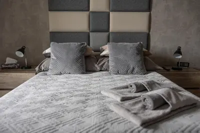 a bedroom with a bed with towels on it at Premium Apartment Eleven in Zator