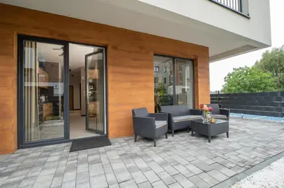 a patio with chairs and a table on a building at Premium Apartment Eleven in Zator
