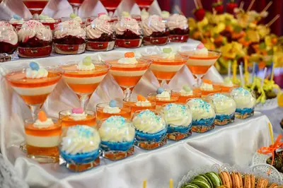 a buffet of desserts and drinks in wine glasses at Hotel Novum & Spa in Niepołomice