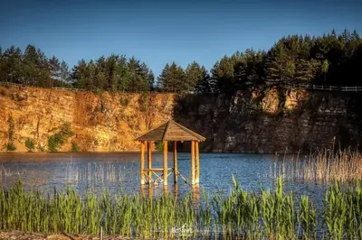 a small gazebo in the middle of a lake at Leśny zakątek malediwy Jacuzzi free in Jaworzno