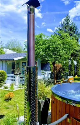 a fountain in a yard next to a hot tub at Leśny zakątek malediwy Jacuzzi free in Jaworzno