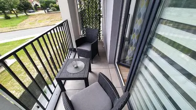 a balcony with a table and chairs on a balcony at Apartament 20 Zator in Zator