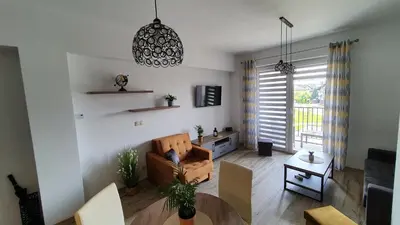 a living room with a couch and a table at Apartament 20 Zator in Zator