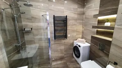 a bathroom with a shower stall and a toilet at Apartament 20 Zator in Zator