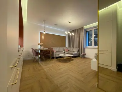 a living room with a couch and a table at CRYSTAL CAVE Apartment in Wieliczka