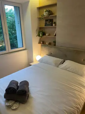 a bedroom with a white bed with towels on it at CRYSTAL CAVE Apartment in Wieliczka