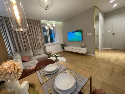 a living room with a table and a couch at CRYSTAL CAVE Apartment in Wieliczka