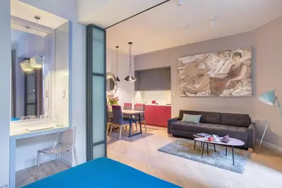 a living room with a couch and a table at Cadena Gallery Apartments Witkacy in Kraków