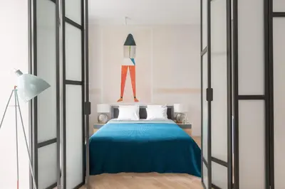 a bedroom with a bed with a blue blanket at Cadena Gallery Apartments Witkacy in Kraków