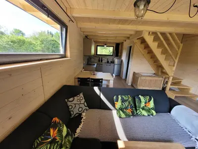 a couch in the middle of a tiny house at Widokówka in Zawoja