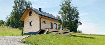 a small house on top of a grassy hill at Duchałówka 2.0 in Koszarawa