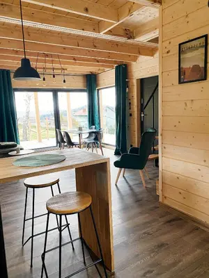 a kitchen and living room of a log cabin at Duchałówka 2.0 in Koszarawa
