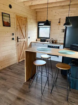 a kitchen with a counter and stools in a cabin at Duchałówka 2.0 in Koszarawa