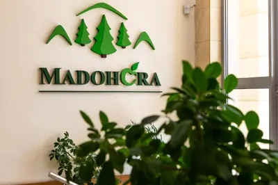 a sign for a madolato sign on a wall at Korona Żywca - MADOHORA in Ślemień
