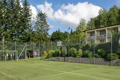 a tennis court with a net on top of it at Korona Żywca - MADOHORA in Ślemień