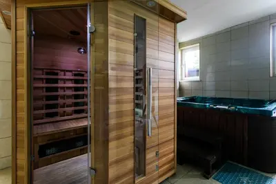 a bathroom with a shower and a tub in a room at Korona Żywca - MADOHORA in Ślemień