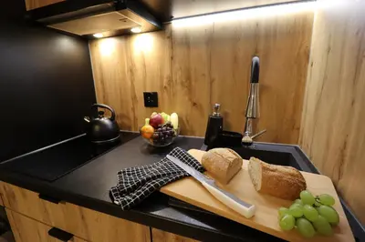 a cutting board with bread and grapes on a kitchen counter at Sander Apartments in Kraków