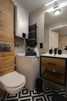 a bathroom with a toilet and a sink at Sander Apartments in Kraków