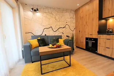a living room with a couch and a table at Sander Apartments in Kraków