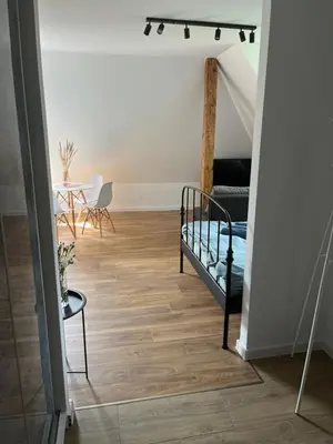 a living room with a bed and a table at Apartament Willa Bellevue in Rabka