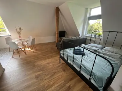 a bedroom with a bed and a table and chairs at Apartament Willa Bellevue in Rabka