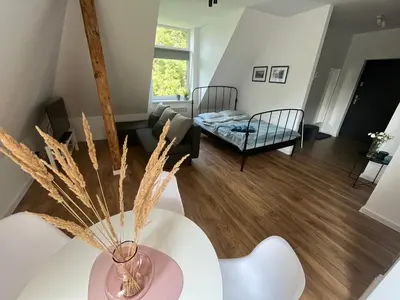 a living room with a vase on a table at Apartament Willa Bellevue in Rabka