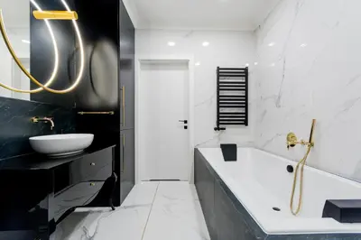 a black and white bathroom with a tub and a sink at Luxury penthouse with jacuzzi in Kraków