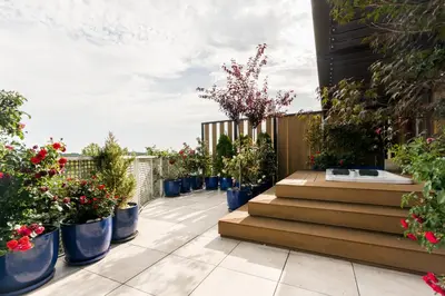 a garden with potted plants on a balcony at Luxury penthouse with jacuzzi in Kraków