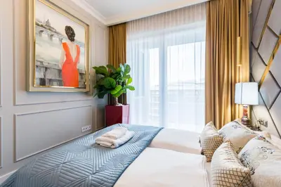 a bedroom with a bed and a window at Luxury penthouse with jacuzzi in Kraków